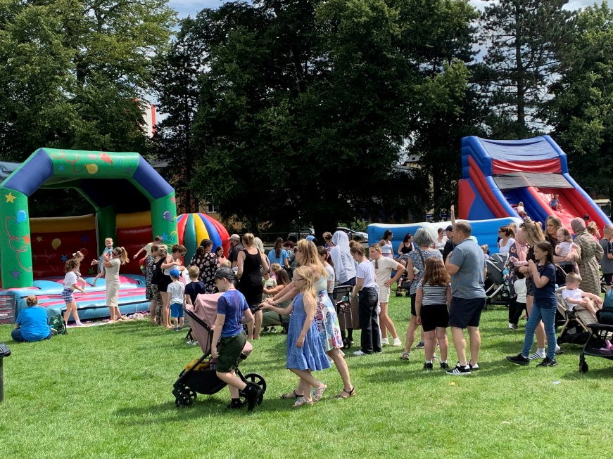 A group of people in front of a bouncy castle