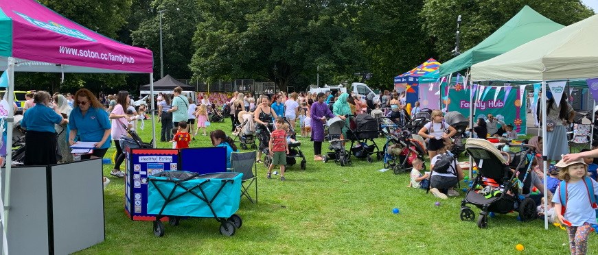 A crowd of people and several stalls