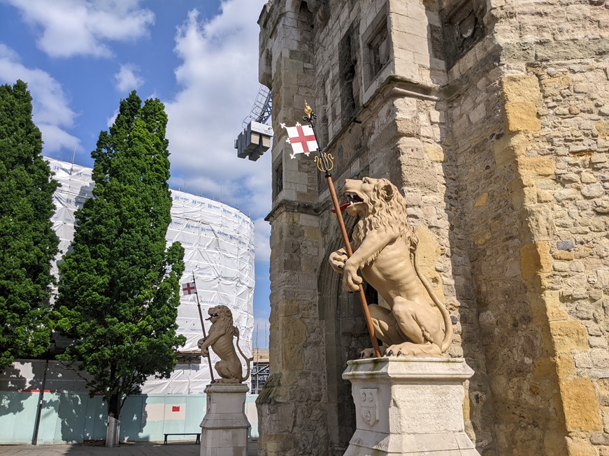 A photo of the Bargate Lions with the Bargate Quarter development in the background