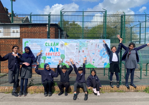 School children around a Clean Air banner