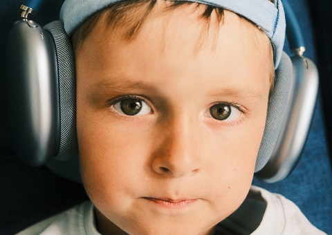 A young boy wearing large headphones