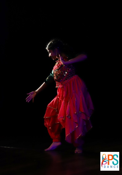A person performing an Indian-style dance. Logo for PS Dance