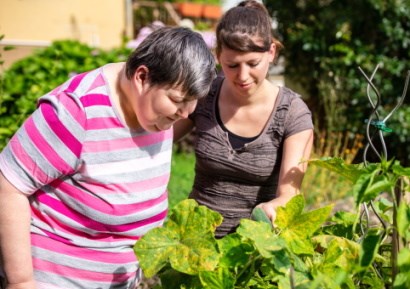 Woman with disabled woman in garden
