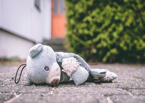 A torn teddy lying on the ground