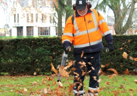 A council operative using a leaf blower
