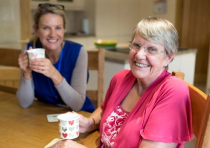 Woman enjoying cuppa with support worker