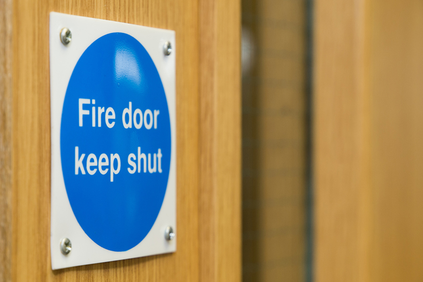 A fire door with a sign saying "Fire door keep shut"